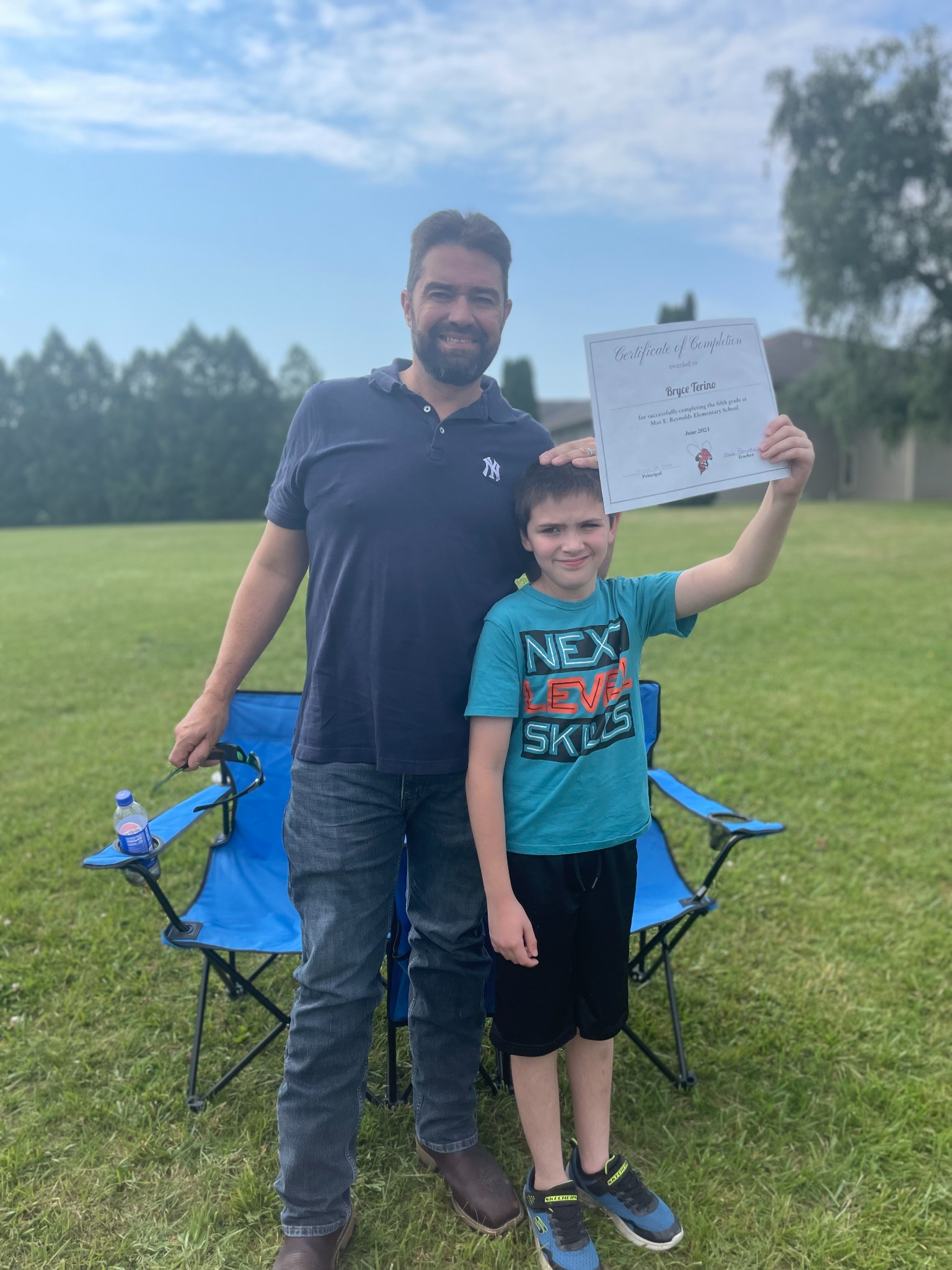 Sam celebrating a school milestone with his son